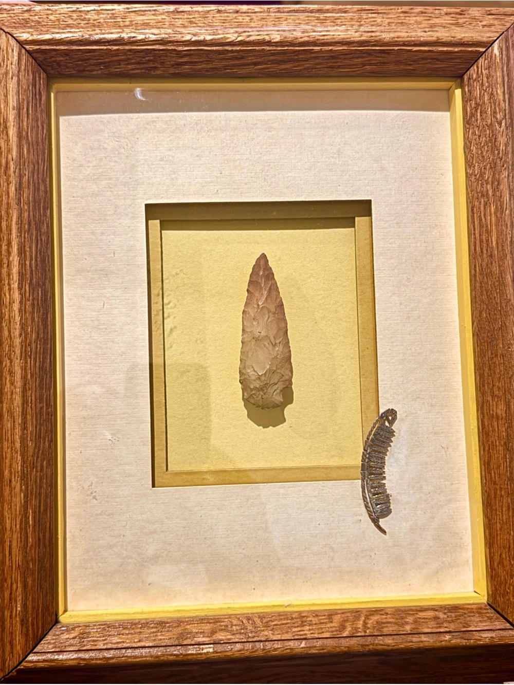 Native American arrowhead with a sterling silver feather designer art.